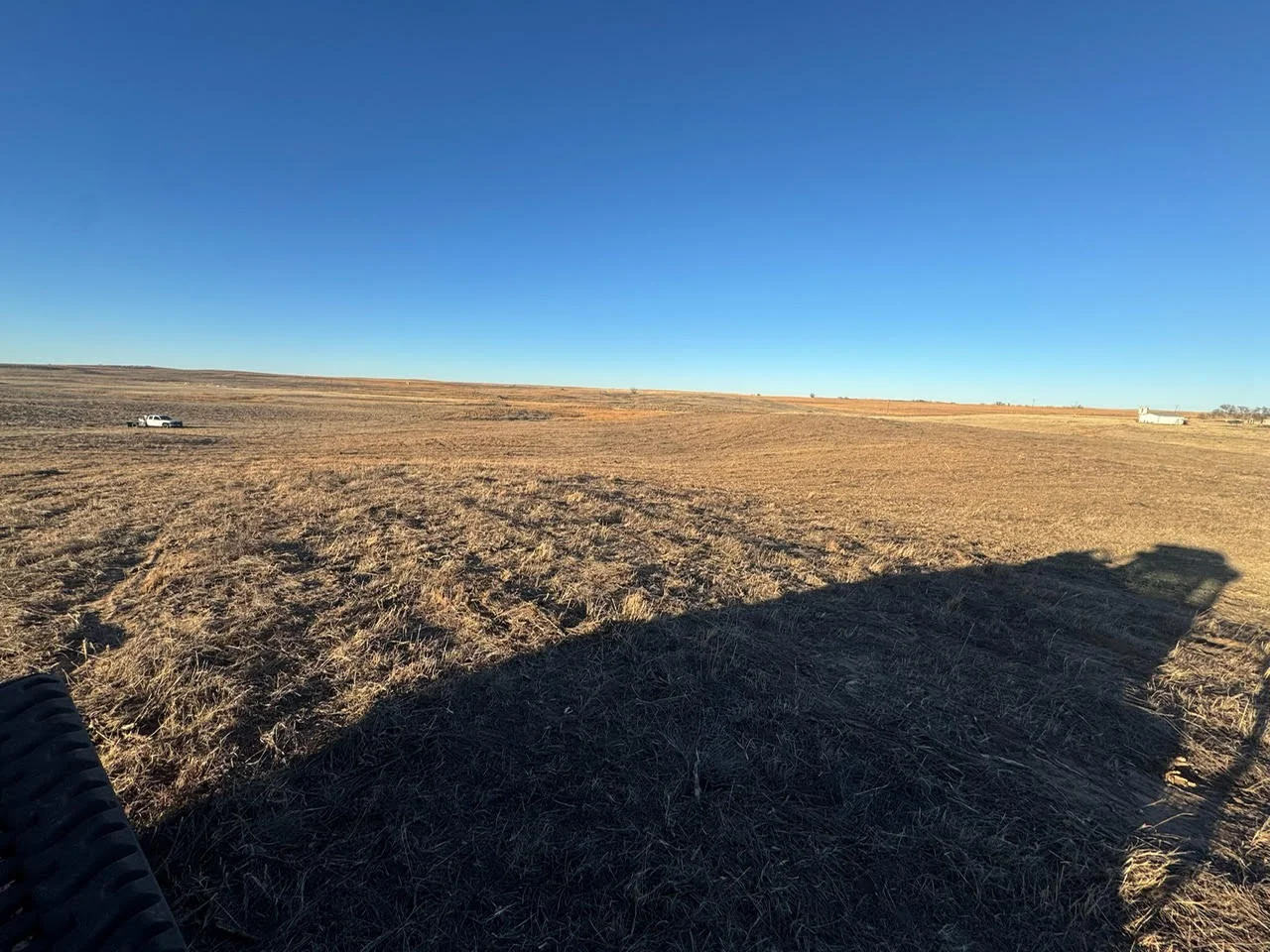Cleared agricultural land with excavated soil and removed vegetation across wide property